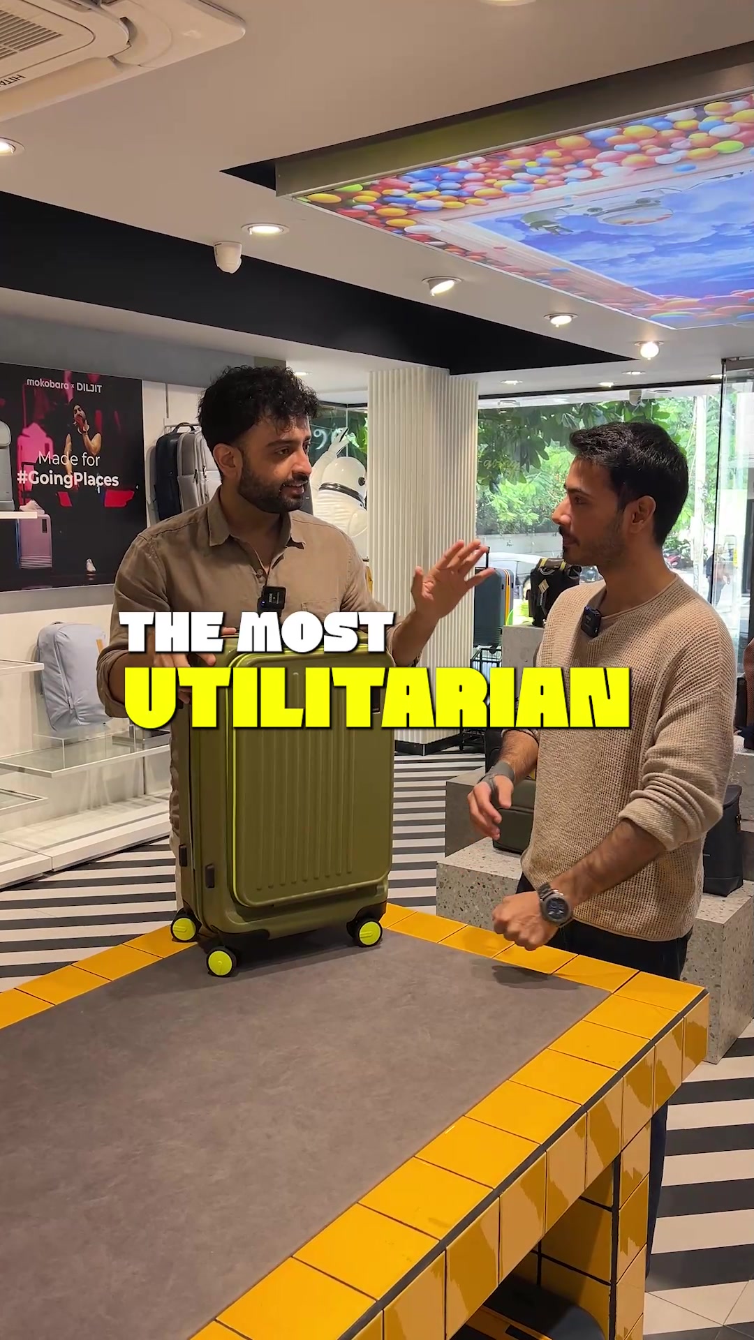 Mokobara ad frame reading THE MOST UTILITARIAN with a yellow cabin suitcase