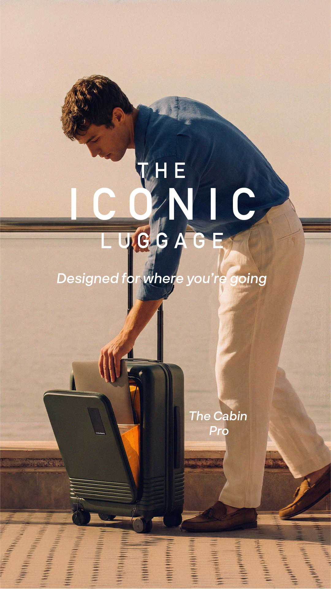 Mokobara product static ad: The Cabin Pro suitcase with a front laptop compartment on a coastal balcony